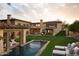 Lush backyard features a swimming pool, lounge chairs, and various outdoor structures at 7525 N Shadow Mountain Rd, Paradise Valley, AZ 85253