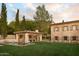 Expansive backyard with a pool, covered patio, and guest house at 7525 N Shadow Mountain Rd, Paradise Valley, AZ 85253