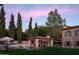 Inviting backyard showcasing pool, outdoor kitchen, verdant lawn, and charming stone details at 7525 N Shadow Mountain Rd, Paradise Valley, AZ 85253