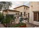 Charming backyard with an outdoor kitchen, vegetable garden, and Mediterranean architecture at 7525 N Shadow Mountain Rd, Paradise Valley, AZ 85253