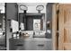 Contemporary bathroom featuring a dark vanity, sleek mirror, and modern fixtures, creating a minimalist and sophisticated space at 7525 N Shadow Mountain Rd, Paradise Valley, AZ 85253