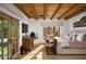 Elegant bedroom featuring wood beams, a cozy fireplace, and French doors opening to the outdoors at 7525 N Shadow Mountain Rd, Paradise Valley, AZ 85253