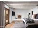 Well-lit bedroom with stone fireplace and hardwood flooring at 7525 N Shadow Mountain Rd, Paradise Valley, AZ 85253