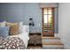 Bedroom featuring patterned wallpaper, a cozy bed, and a door leading to an outdoor area or balcony at 7525 N Shadow Mountain Rd, Paradise Valley, AZ 85253