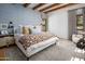 Beautiful bedroom with patterned wallpaper, wood beam ceilings, and a comfortable seating area near a large window at 7525 N Shadow Mountain Rd, Paradise Valley, AZ 85253