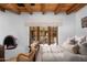 Serene bedroom with a fireplace, beamed ceilings, and cozy seating near a window at 7525 N Shadow Mountain Rd, Paradise Valley, AZ 85253