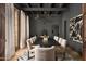Elegant dining room with dark gray walls, modern lighting, and seating for ten at 7525 N Shadow Mountain Rd, Paradise Valley, AZ 85253