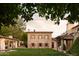 Beautiful stone home with a guest house, an expansive green lawn, and mature trees at 7525 N Shadow Mountain Rd, Paradise Valley, AZ 85253