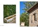 Exterior view of stone home with a water feature, window with shutters and red tile roof at 7525 N Shadow Mountain Rd, Paradise Valley, AZ 85253