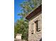 Exterior architectural detail of a stone house with red tile roof and wood shutters at 7525 N Shadow Mountain Rd, Paradise Valley, AZ 85253