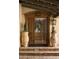 Ornate wooden front door with decorative carvings and potted plants at 7525 N Shadow Mountain Rd, Paradise Valley, AZ 85253
