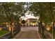 Elegant home with mature landscaping framed by trees and stone walls at 7525 N Shadow Mountain Rd, Paradise Valley, AZ 85253