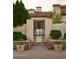 Charming courtyard entrance with a rustic gate and landscaped planters at 7525 N Shadow Mountain Rd, Paradise Valley, AZ 85253