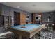 Game room featuring a pool table, dark walls, and unique geometric patterned floors at 7525 N Shadow Mountain Rd, Paradise Valley, AZ 85253
