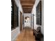 Hallway with wood floors, beam ceilings, and bench seating at 7525 N Shadow Mountain Rd, Paradise Valley, AZ 85253