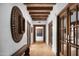 Hallway featuring wood beam ceilings, hardwood floors, and decorative accents at 7525 N Shadow Mountain Rd, Paradise Valley, AZ 85253