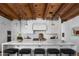 Stylish kitchen featuring a large island with marble countertops, seating and wood beam ceilings at 7525 N Shadow Mountain Rd, Paradise Valley, AZ 85253