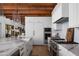 Bright kitchen with marble counters, an island, stainless steel appliances, and wood floors at 7525 N Shadow Mountain Rd, Paradise Valley, AZ 85253