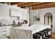 Spacious kitchen with a large marble countertop, white cabinets, and modern appliances at 7525 N Shadow Mountain Rd, Paradise Valley, AZ 85253