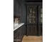 Chic kitchen featuring dark cabinets, marble countertops, and designer accents at 7525 N Shadow Mountain Rd, Paradise Valley, AZ 85253