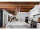 Spacious kitchen with marble counters, stainless steel appliances, and wood beam ceilings at 7525 N Shadow Mountain Rd, Paradise Valley, AZ 85253