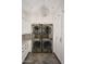 Bright laundry room featuring a stacked washer and dryer unit and ample white cabinet space at 7525 N Shadow Mountain Rd, Paradise Valley, AZ 85253