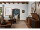 Cozy living area featuring leather chairs, vintage record player, and seamless flow into the dining space at 7525 N Shadow Mountain Rd, Paradise Valley, AZ 85253