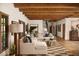 Spacious living room with hardwood floors, a white sectional, and decorative rug at 7525 N Shadow Mountain Rd, Paradise Valley, AZ 85253