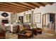 Comfortable living room with fireplace, wood ceiling beams, and leather chairs at 7525 N Shadow Mountain Rd, Paradise Valley, AZ 85253