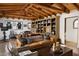 Open living room boasts exposed beam ceiling, comfortable leather couch, and built-in shelving at 7525 N Shadow Mountain Rd, Paradise Valley, AZ 85253
