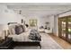 Bright main bedroom with wood beam ceiling, doors to the outside and a cozy window seat at 7525 N Shadow Mountain Rd, Paradise Valley, AZ 85253