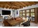Bright office featuring exposed beam ceiling, large wooden desk, and access to an outdoor patio at 7525 N Shadow Mountain Rd, Paradise Valley, AZ 85253