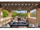 Comfortable covered outdoor patio with fire pit, seating, and stunning mountain views at 7525 N Shadow Mountain Rd, Paradise Valley, AZ 85253