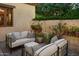 Inviting outdoor patio with cushioned seating, lush greenery, and a tranquil ambiance at 7525 N Shadow Mountain Rd, Paradise Valley, AZ 85253