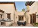 Charming outdoor patio with terracotta tiles, seating, and spiral staircase at 7525 N Shadow Mountain Rd, Paradise Valley, AZ 85253