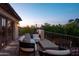 Twilight view of a cozy patio with outdoor seating and scenic foliage in the background at 7525 N Shadow Mountain Rd, Paradise Valley, AZ 85253