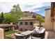 Relaxing patio with outdoor furniture and views of a stone building, greenery, and a mountain at 7525 N Shadow Mountain Rd, Paradise Valley, AZ 85253