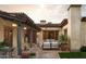 Inviting outdoor patio with covered seating, string lights, and a fireplace at 7525 N Shadow Mountain Rd, Paradise Valley, AZ 85253
