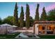 Inviting pool area with a cozy cabana, lounge chairs, and tall trees providing shade and privacy at 7525 N Shadow Mountain Rd, Paradise Valley, AZ 85253