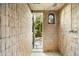 Spa-like shower with stone tile surround, and an open door for natural light and air flow at 7525 N Shadow Mountain Rd, Paradise Valley, AZ 85253