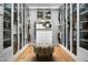 Spacious walk-in closet with custom shelving and wood floor at 7525 N Shadow Mountain Rd, Paradise Valley, AZ 85253