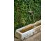 Close up of a charming stone water feature surrounded by lush greenery at 7525 N Shadow Mountain Rd, Paradise Valley, AZ 85253