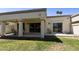 The backyard has a grassy yard and a covered patio with an outdoor seating area at 7834 E Mariposa Way, Mesa, AZ 85208
