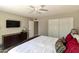 Bedroom with a large bed, a flat-screen TV, a dresser, and sliding closet doors at 7834 E Mariposa Way, Mesa, AZ 85208