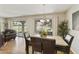 Bright dining area featuring a marble-topped table, pendant lighting, and large windows overlooking the outdoors at 7834 E Mariposa Way, Mesa, AZ 85208