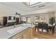 Open-concept kitchen and living area with hardwood floors, recessed lighting, and backyard views at 7834 E Mariposa Way, Mesa, AZ 85208