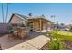 Enjoy outdoor living with a bar, putting green, covered patio and sparkling pool at 7966 W Surrey Ave, Peoria, AZ 85381