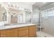 Bathroom features a large mirror, double sinks and a stand up shower at 7966 W Surrey Ave, Peoria, AZ 85381