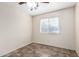 Neutral-toned bedroom with tile floor, window, and ample natural light at 7966 W Surrey Ave, Peoria, AZ 85381