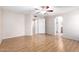 Large primary bedroom features wood floors, ceiling fan, and archway to en-suite bath at 7966 W Surrey Ave, Peoria, AZ 85381